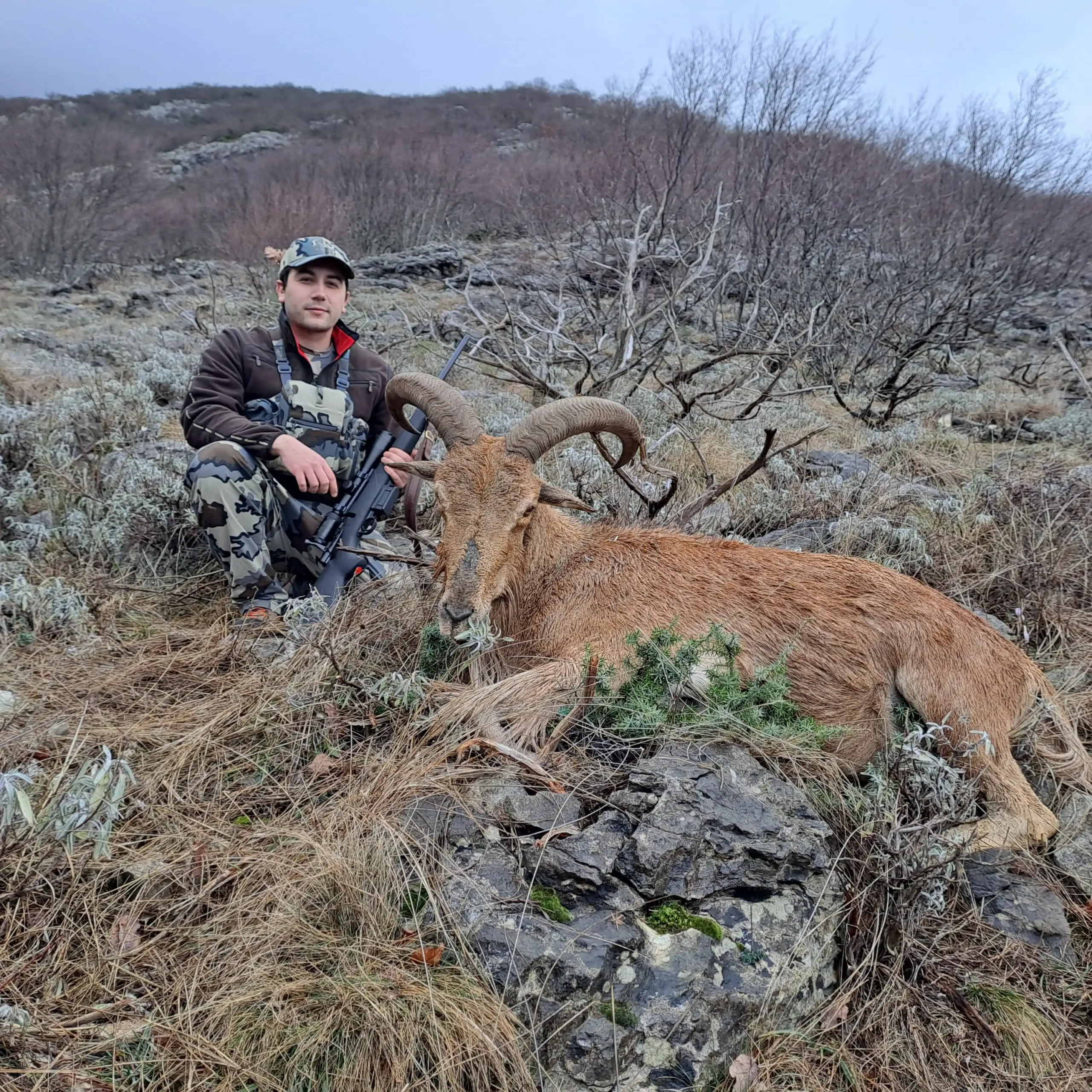 Toni Balić, founder of Teron Hunting Tours, taking picture with his hunted barbary sheep in Croatia