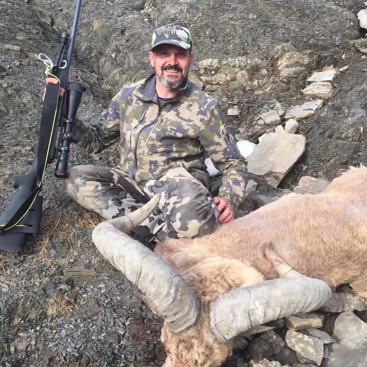 Hunter taking picture with his hunted tur in Dagestan, example of successful client of Teron who went tur hunting in Dagestan